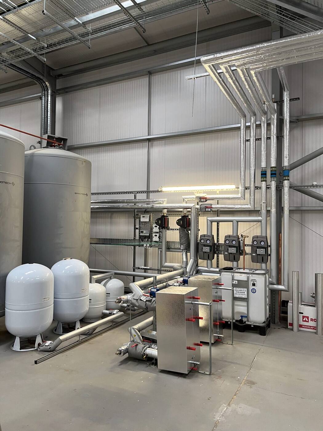 Commercial plant room with pressure vessels and pipework